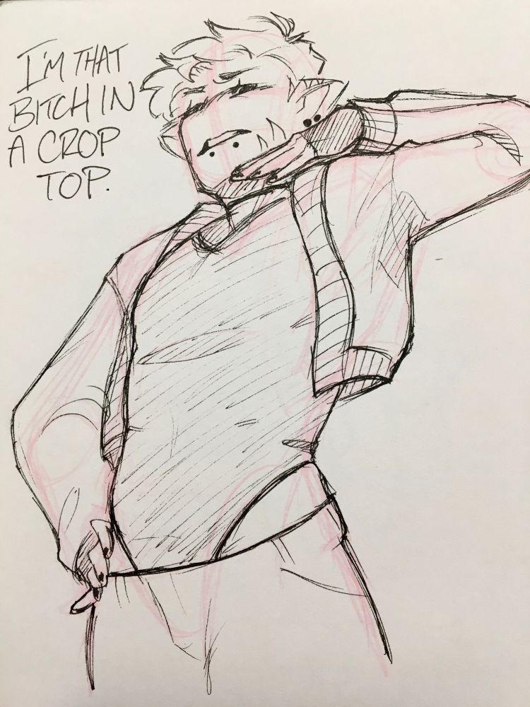 Moch is standing with hips pushed forward and shoulders leaned back, with his right hand on his hip and the left hand under his chin. He is wearing loose pants, a black sleeveless bodysuit and a loose cropped-cardigan on top.