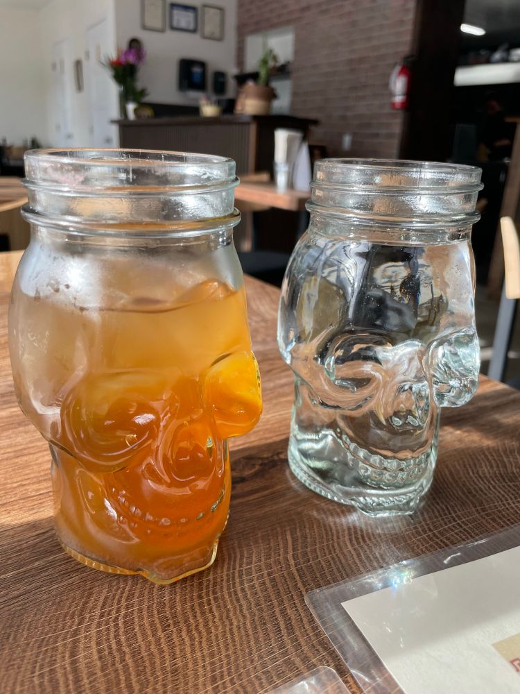 An amber liquid and, of course, a clear liquid in a couple of skull glasses