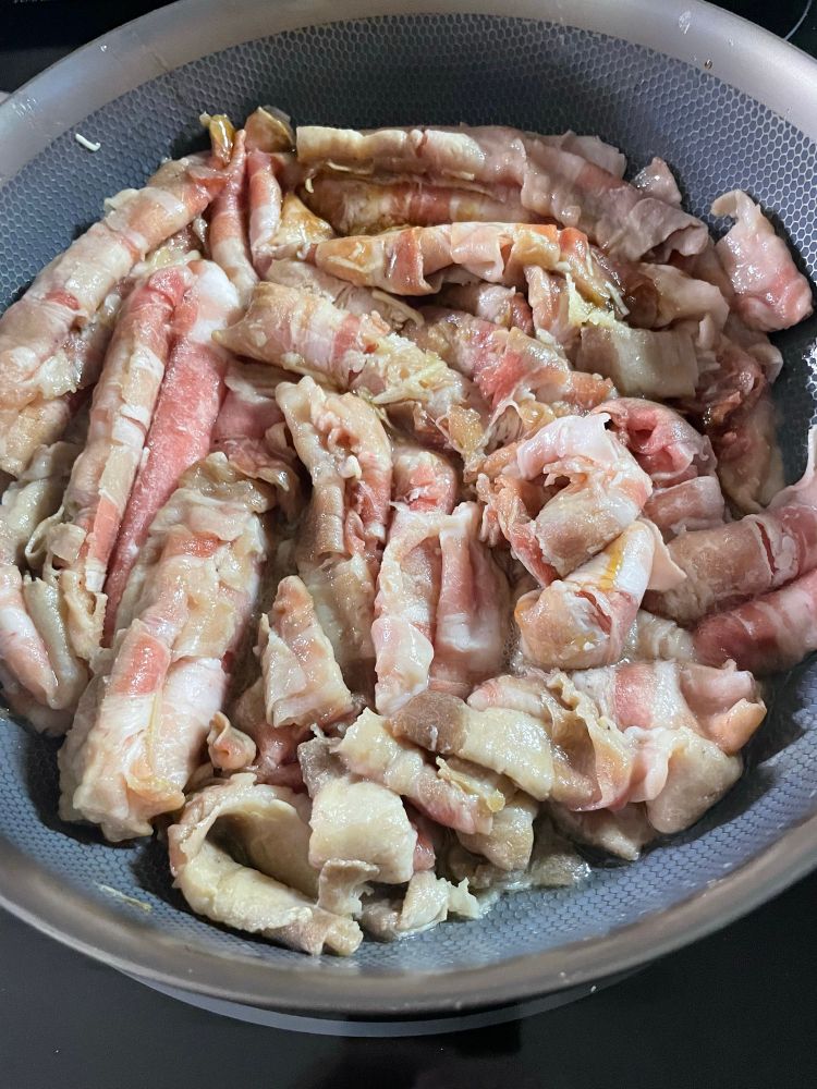 The pork belly and goodies loosening up and cooking down in the skillet