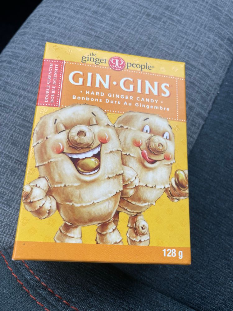 A package of gin-gins, a ginger hard candy featuring ginger people happily sucking on the ginger candy
