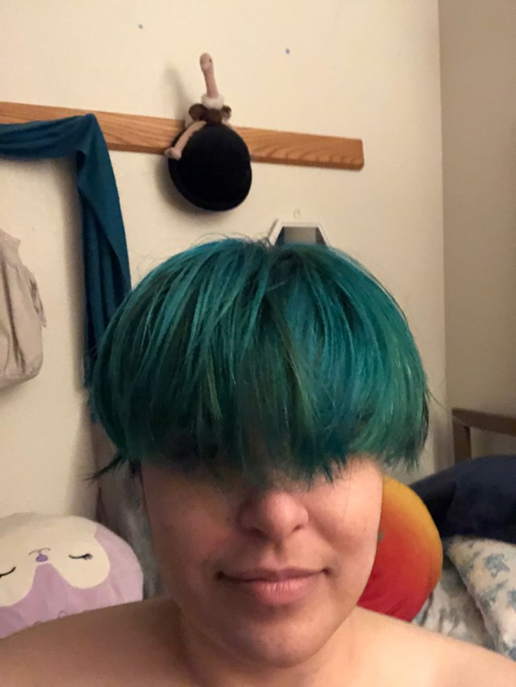 selfie with green overgrown bangs looks like a bowl cut lol