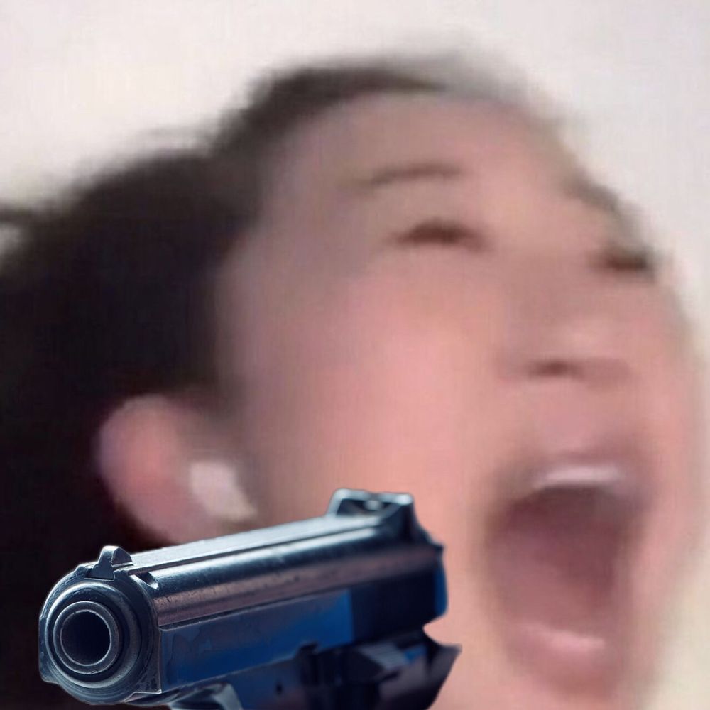 blurred image of actress Sandra Oh screaming with a gun pointed at viewer photoshopped in