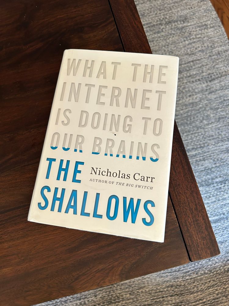 copy of the book “the shallows: what the internet is doing to our brains” by nicholas carr