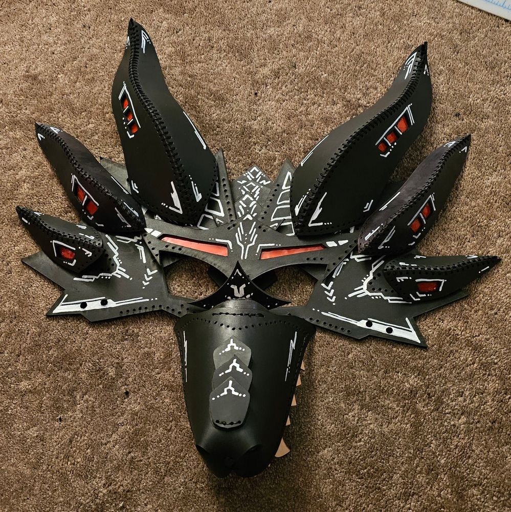 Black leather dragon mask with red and white accents