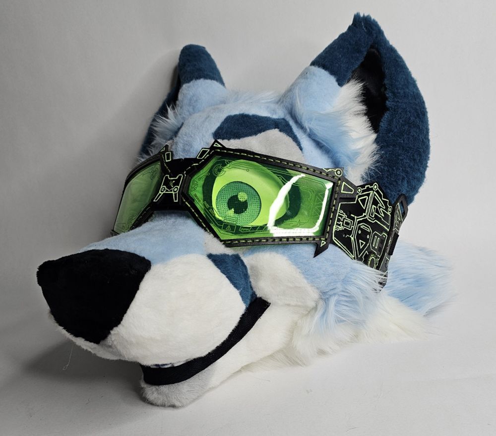 Green fursuit goggles on a fursuit