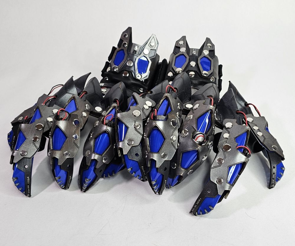 A set of silver claws with blue windows for green LEDs