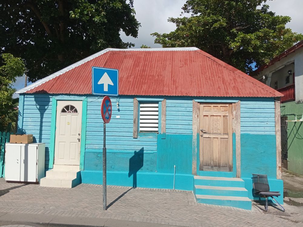 Wooden blue house in Philipsburg with red roof