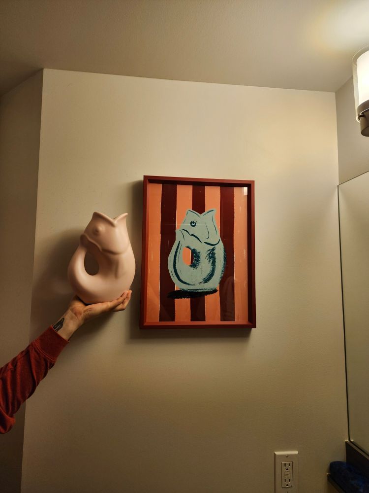 Gurgle pot portrait in a frame next to an actual gurgle pot