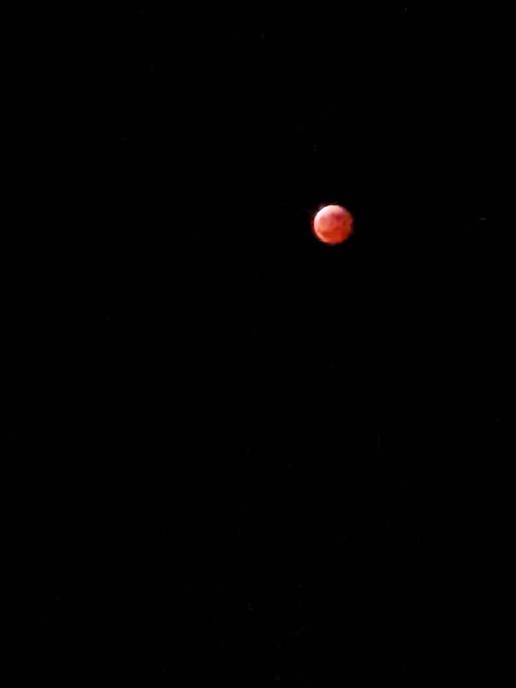 Red moon against a black sky during a lunar eclipse 