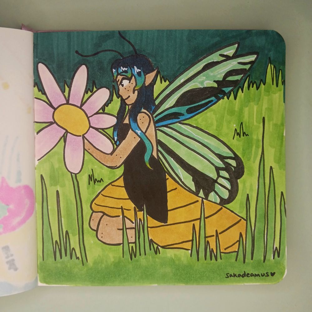 Girl with butterfly wings based off of a Queen Alexandra's birdwing holding a flower while kneeling in the grass