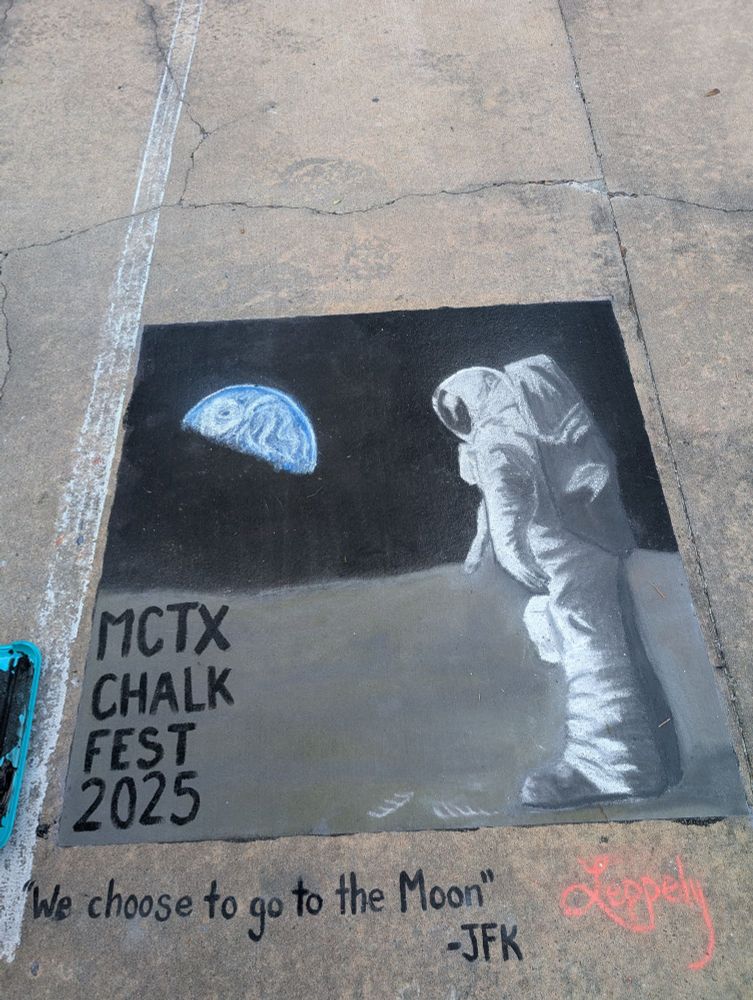 A photo of a 5 ft x 5 ft square on the concrete with an image of an astronaut (Buzz Aldrin) on a moonwalk with the Earth in the background. Image text says MCTX CHALK FEST 2025, and below that is a quote from a speech by JFK in 1962: "We choose to go to the Moon."