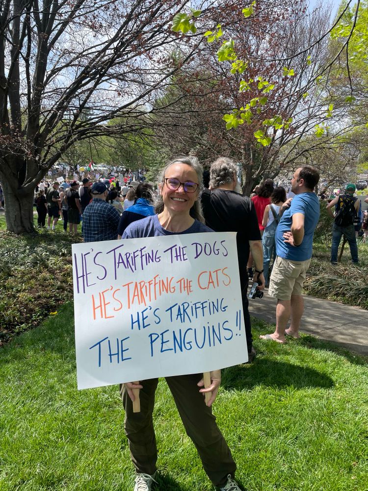 Sign saying, “He’s tariffing the dogs, he’s tariffing the cats, he’s tariffing the penguins!!!”