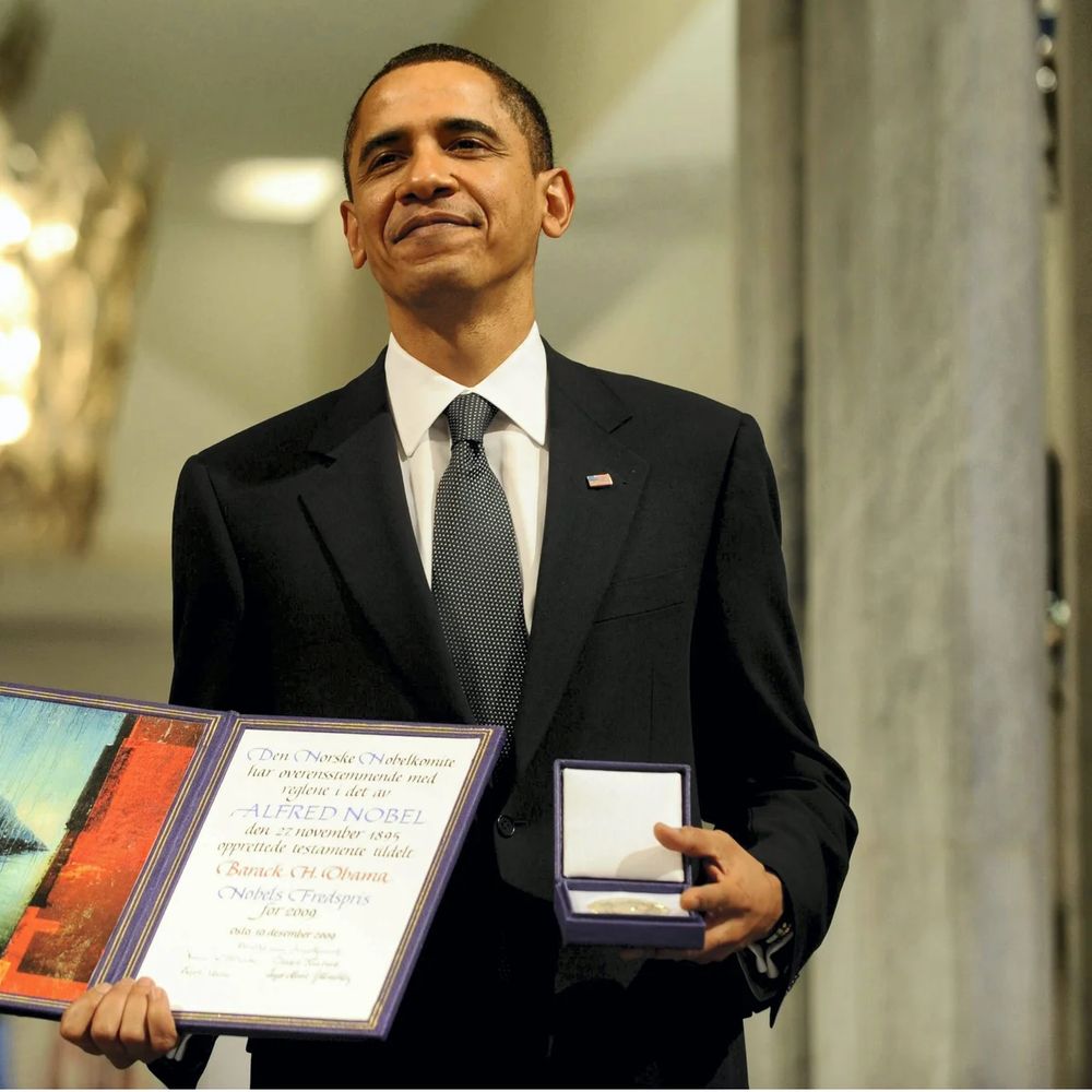 Obama holding his Nobel Peace Prize.