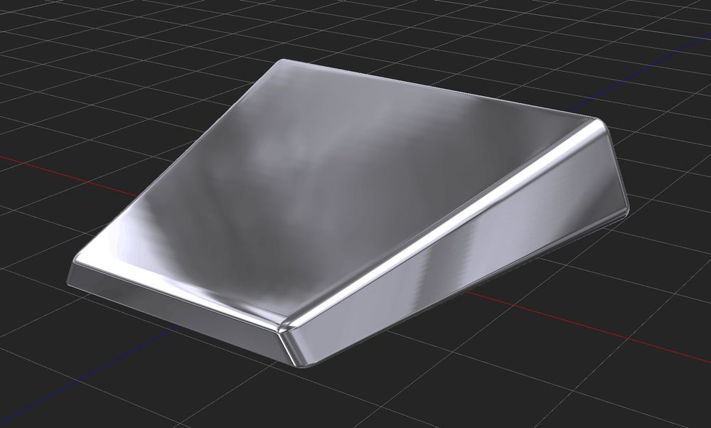 An angular solid chrome block hovers in a 3D design tool.