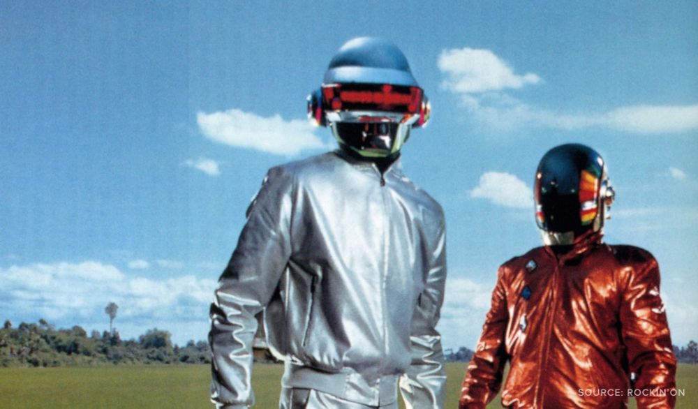 A photo of Daft Punk in a field on a sunny day.