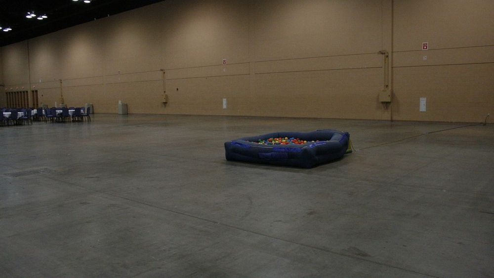 a photo from dashcon with a small ball pit in a large convention ballroom