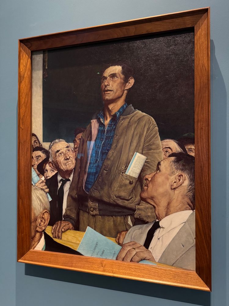 a photo of the oil painting "Freedom of Speech" by Norman Rockwell.

The painting depicts a scene of a 1942 Arlington town meeting in which Jim Edgerton, the lone dissenter to the town selectmen's announced plans to build a new school, as the old one had burned down, was accorded the floor as a matter of protocol. (source: wikipedia)