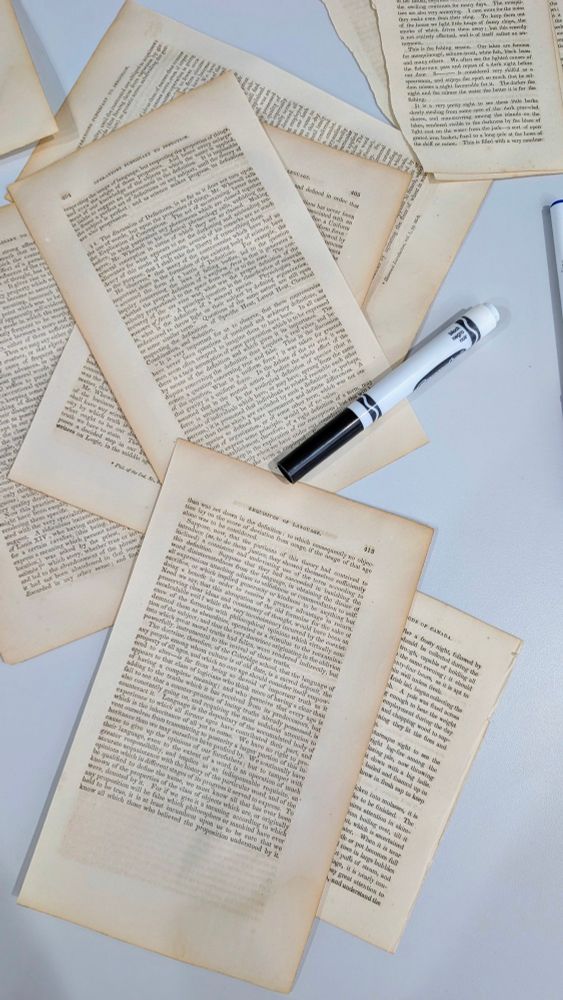 Book pages and a black marker for black out poetry 