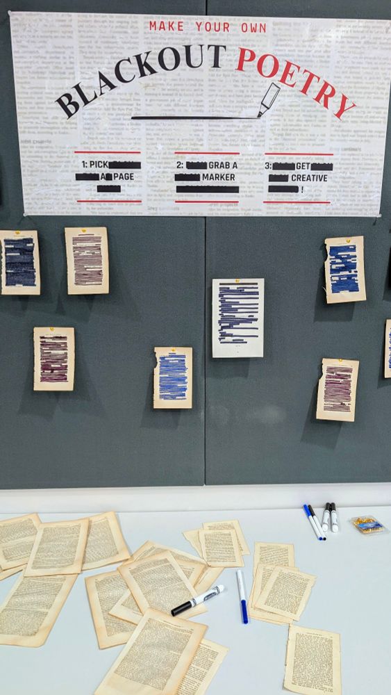 Our black out poetry exhibit with some completed poems and pages and markers to complete poetry on the table.