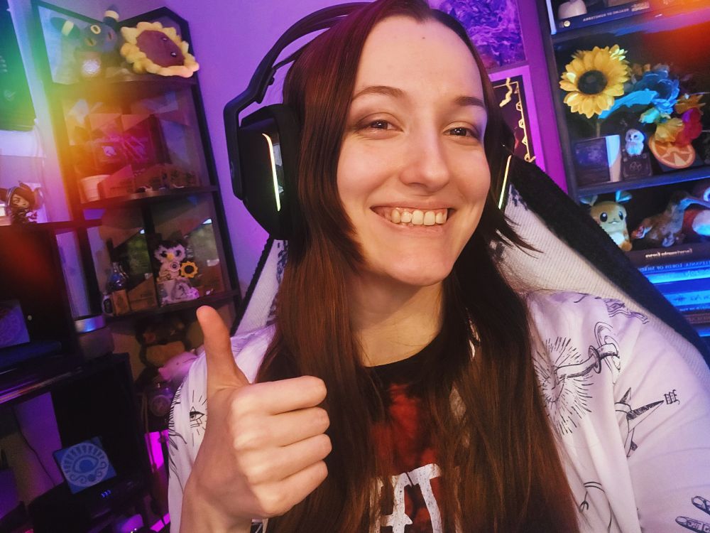 Strixxline smiling and giving a thumbs-up to the camera