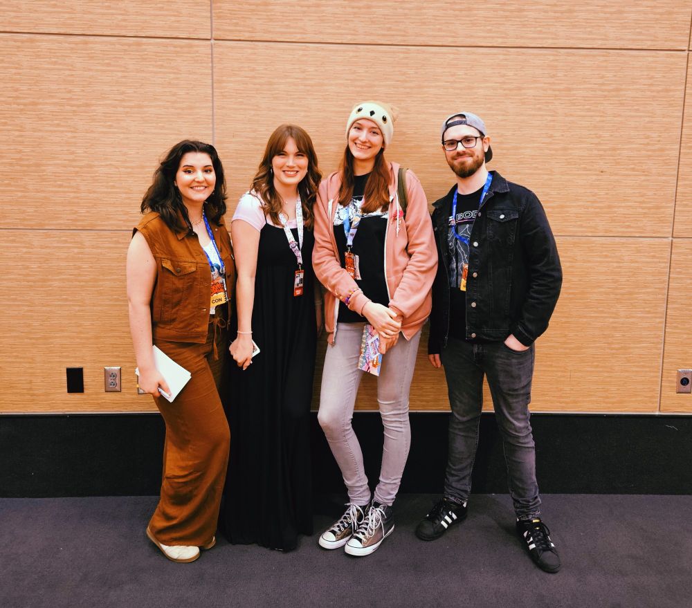 Strixxline posing for a photo with the cast of the Slow Burn Podcast. From left to right, Payton's Corner, Min's Meadow, Strixxline, and NintenTalk.
