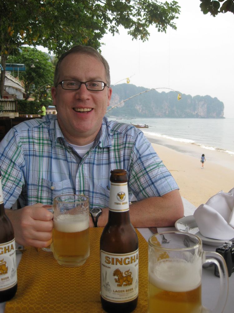 Me having a beer on the beach in Thailand