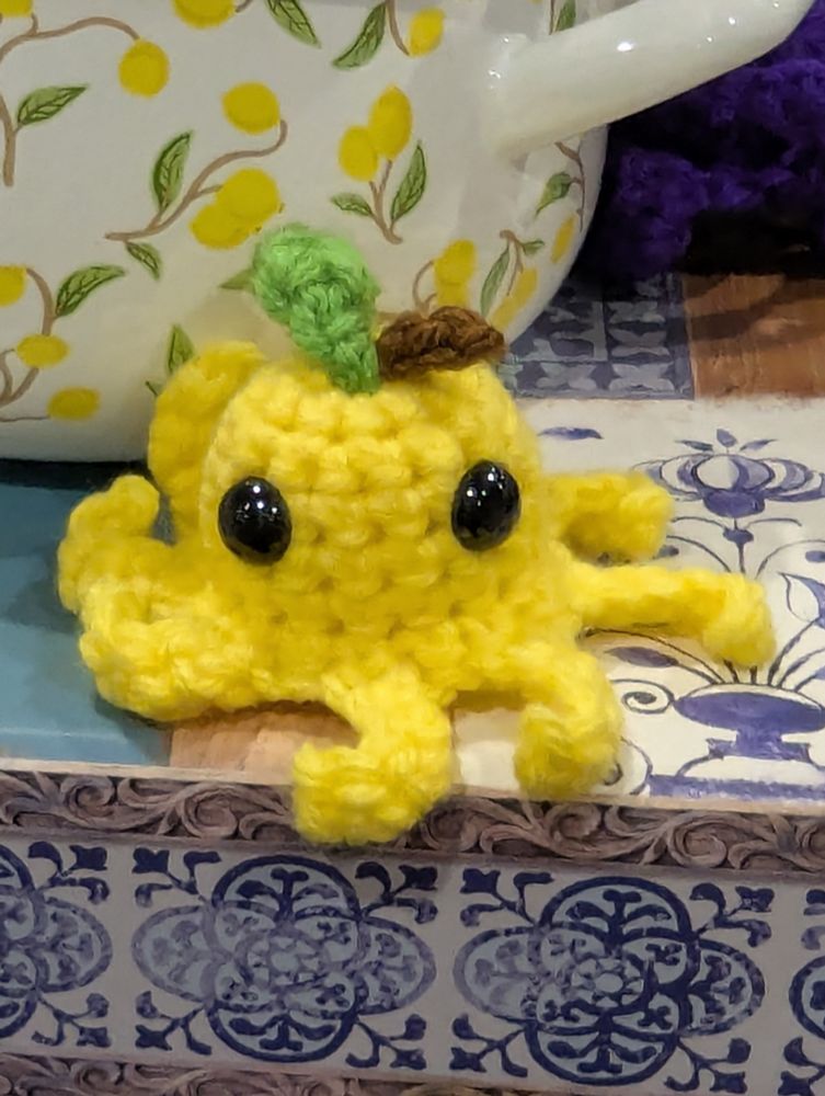 A tiny crocheted lemon octopus