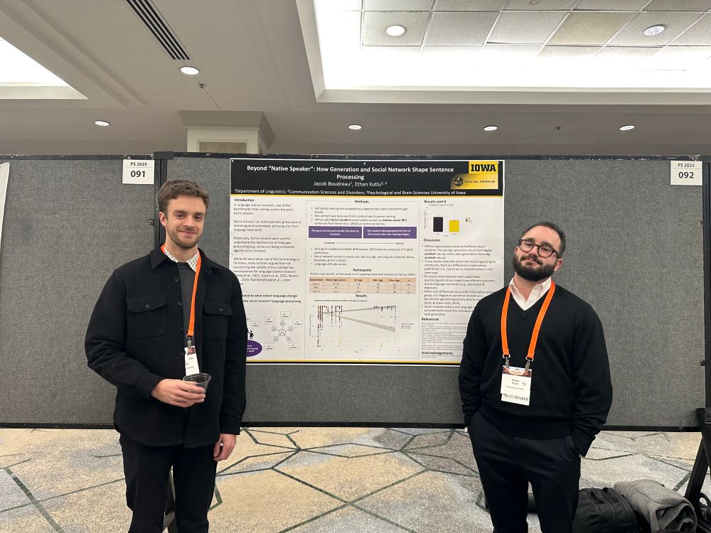 Ethan and Jake posing in front of Jake’s poster. They look very happy 