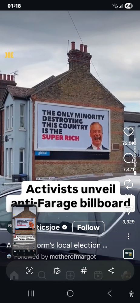 Man posting a billboard with a picture of Farage and the caption 