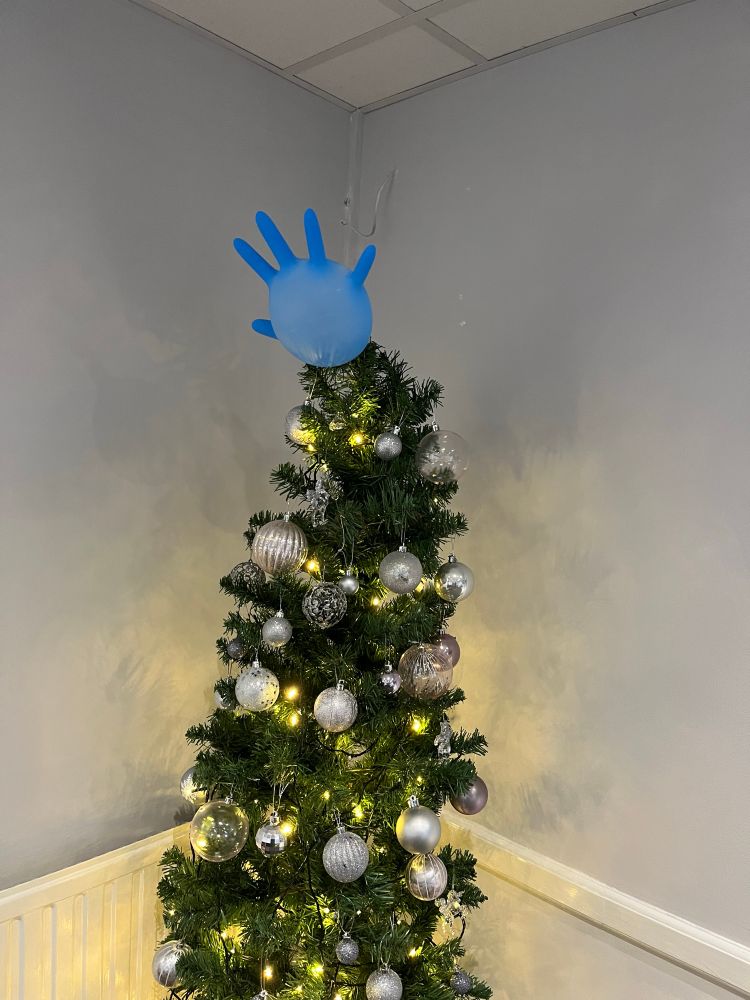 A Christmas tree with an inflated surgical glove as a star 