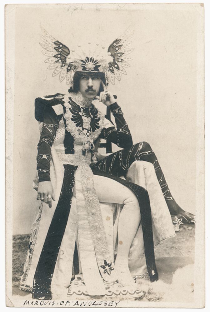 Paget c. 1900, photographed by John Wickens. He’s wearing a winged, jewelled headdress, and an extraordinary, elaborate skirted costume and tights