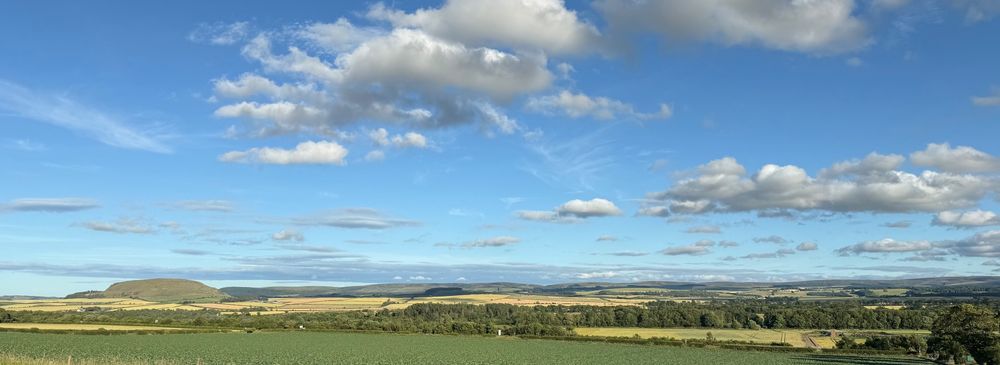 Wide view across fields to distant hills.