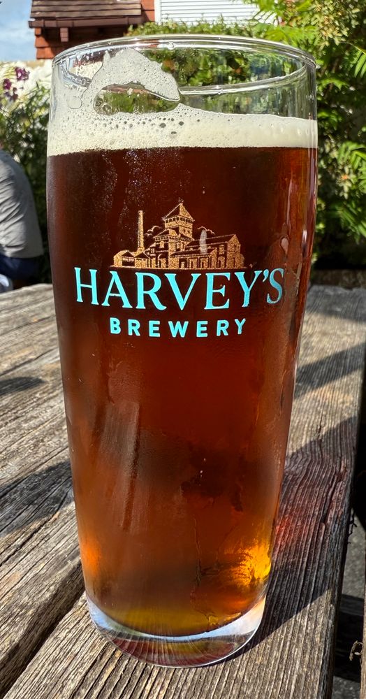 Photograph of beer in a pint glass labelled ‘Harvey’s Brewery’ which is in Lewes in East Sussex