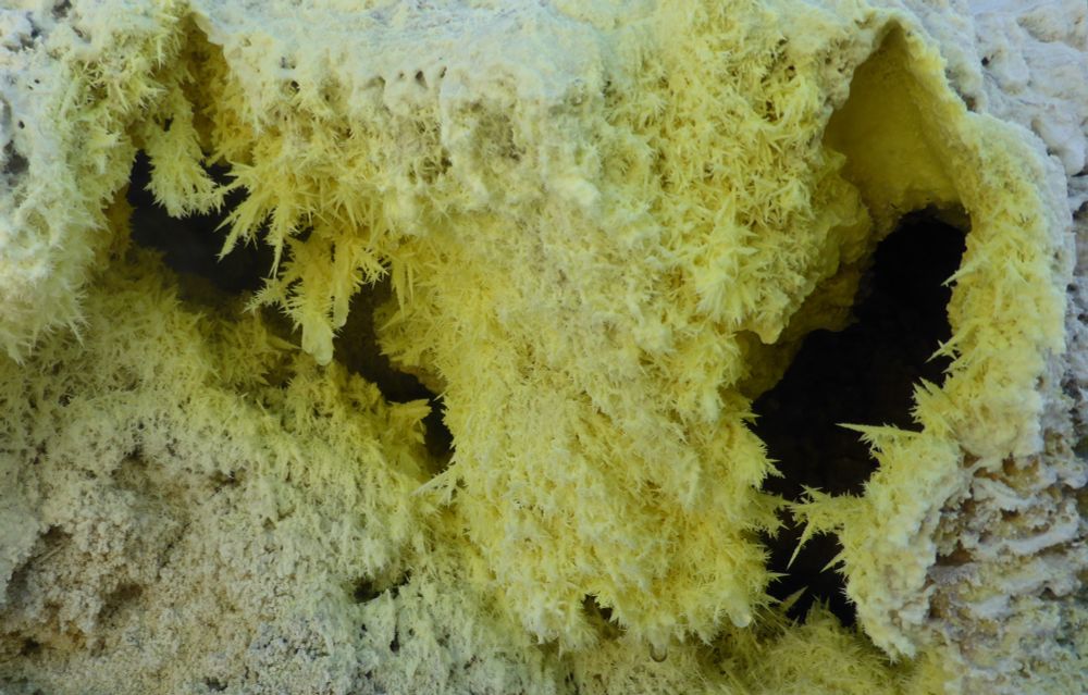 Sharp, pointed yellow crystals of native sulphur.