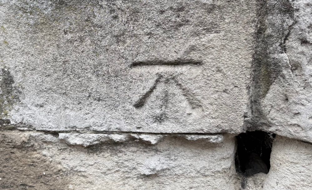 Chiselled benchmark in a block of pale oolitic limestone. 