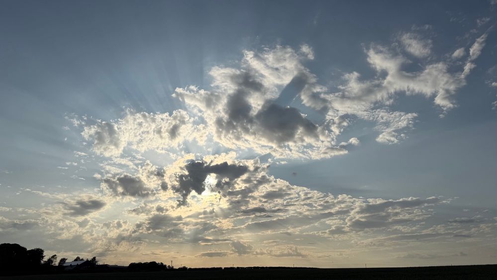 Sun shining out from behind clouds. 