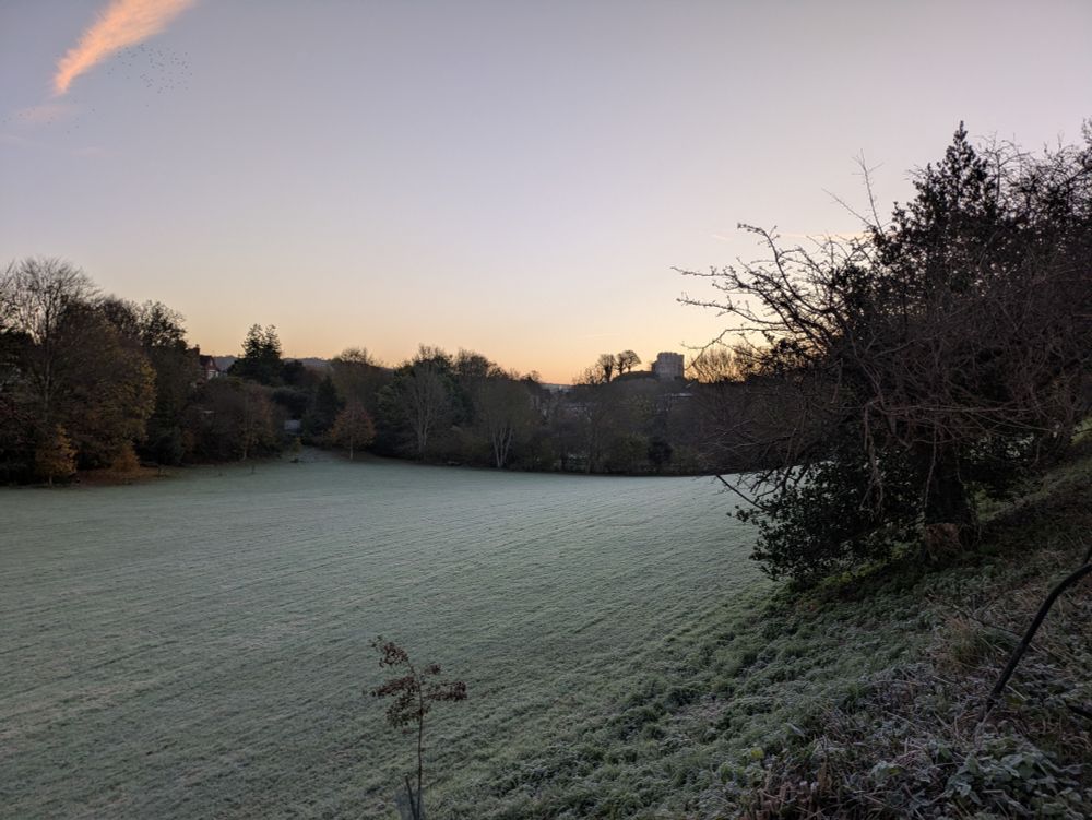 View of castle at sunrise with frosty field 