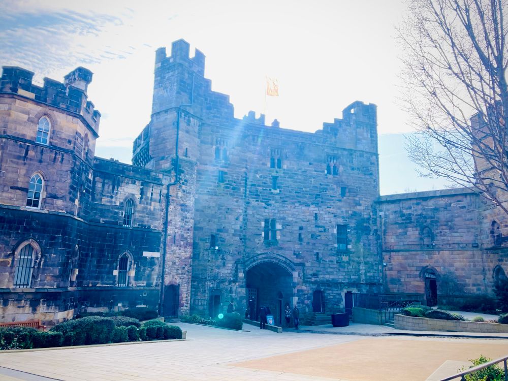 Pic of Lancaster castle main gate from inside the courtyard. Sun shining behind the tower and it's all looking very big and castley and impressive