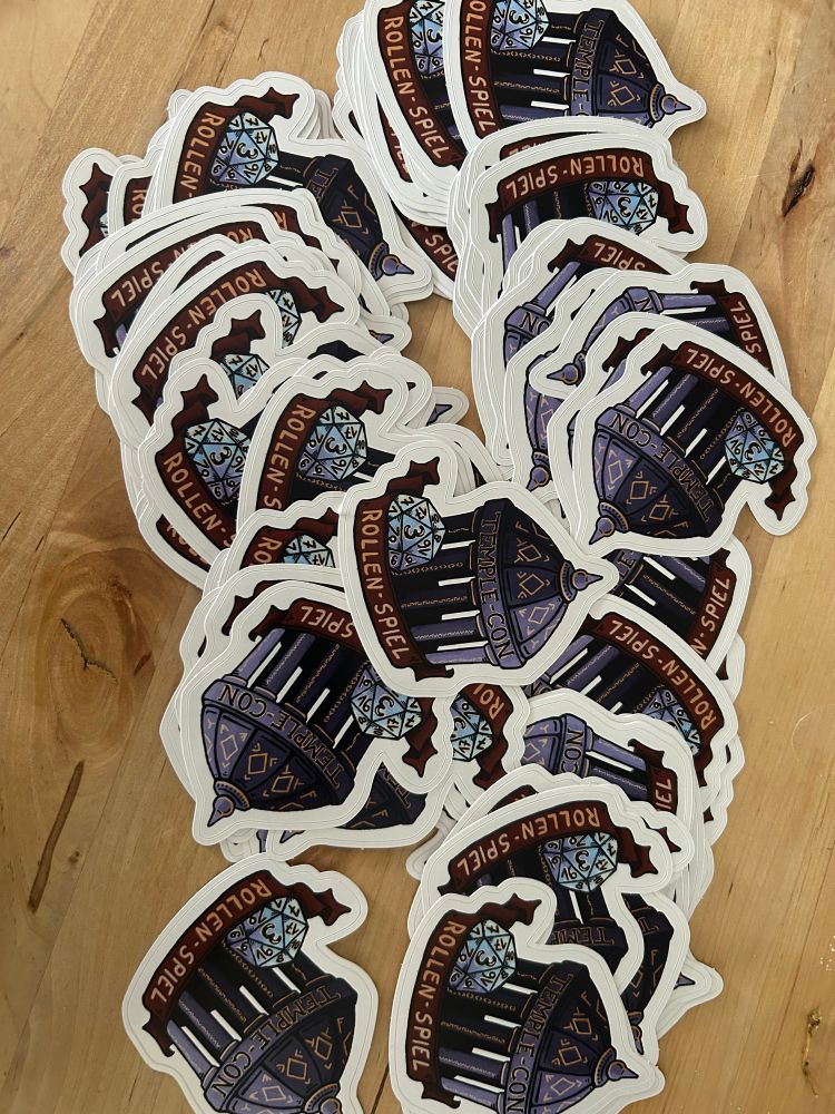 Ein Haufen Aufkleber auf einem Tisch. 