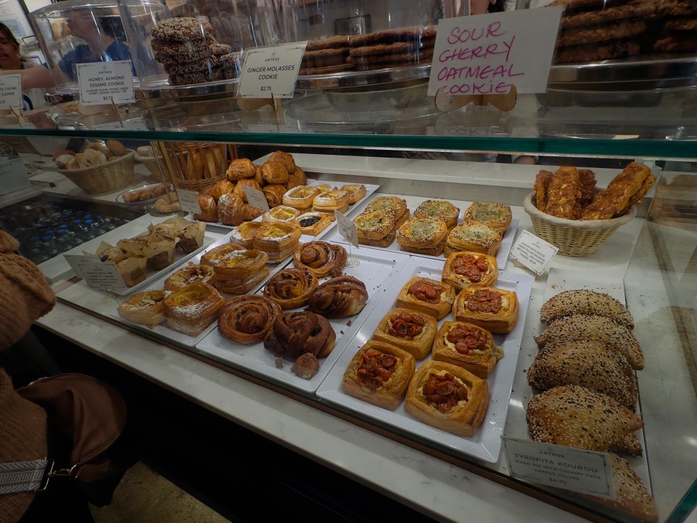 a glass pastry case full of greek pastries, both savory and sweet, as well as french pastries and various cookies (sour cherry!) 