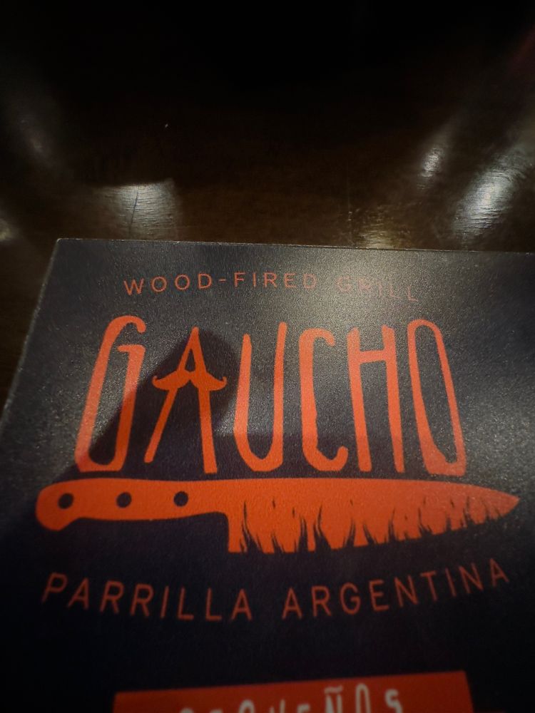 Gaucho menu in orange letters with a knife 
