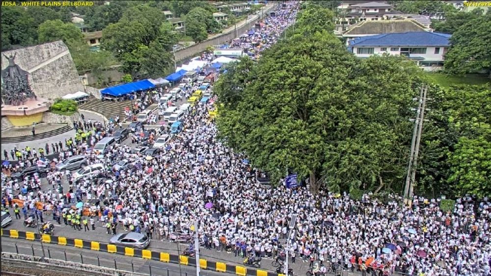 Pic from https://x.com/ABSCBNNews/status/1969648402876285272. A drone shot of a massive crowd at a T-intersection on Epifanio de los Santos Avenue (EDSA), with the People Power Monument on the left. No estimated crowd size yet but it's massive.