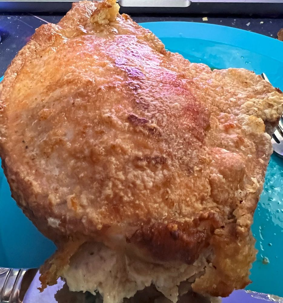 A pan-fried then roasted stuffed pork chop.