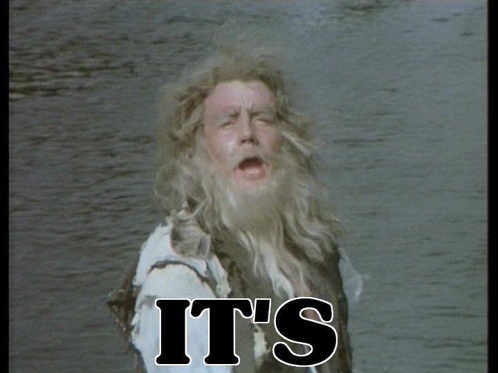 The "It's" Man from "Monty Python's Flying Circus. Michael Palin as a bedraggled man on the seashore who declares "It's" before being interrupted. Caption: "IT'S"