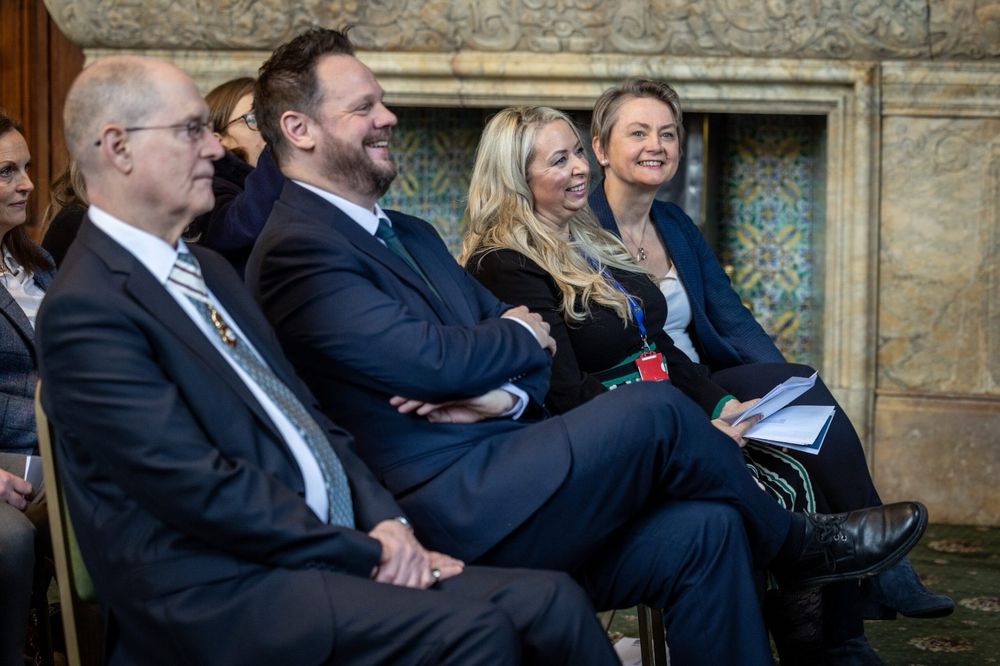 Simon sitting in the audience with other speakers.
