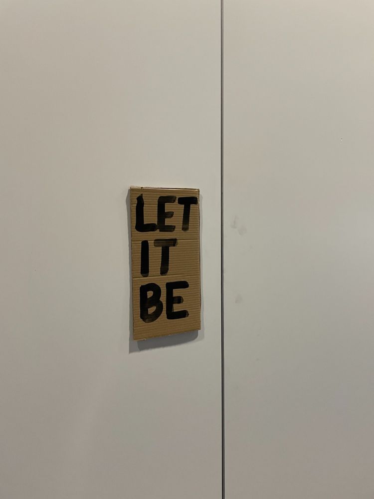 Hand painted sign reading "Let it be"