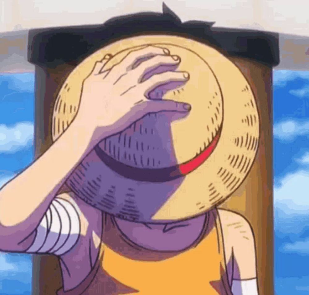 a person wearing a straw hat is covering their face .