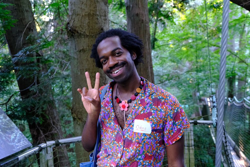 Odera throwing up the peace sign at the resting point of the tree walk