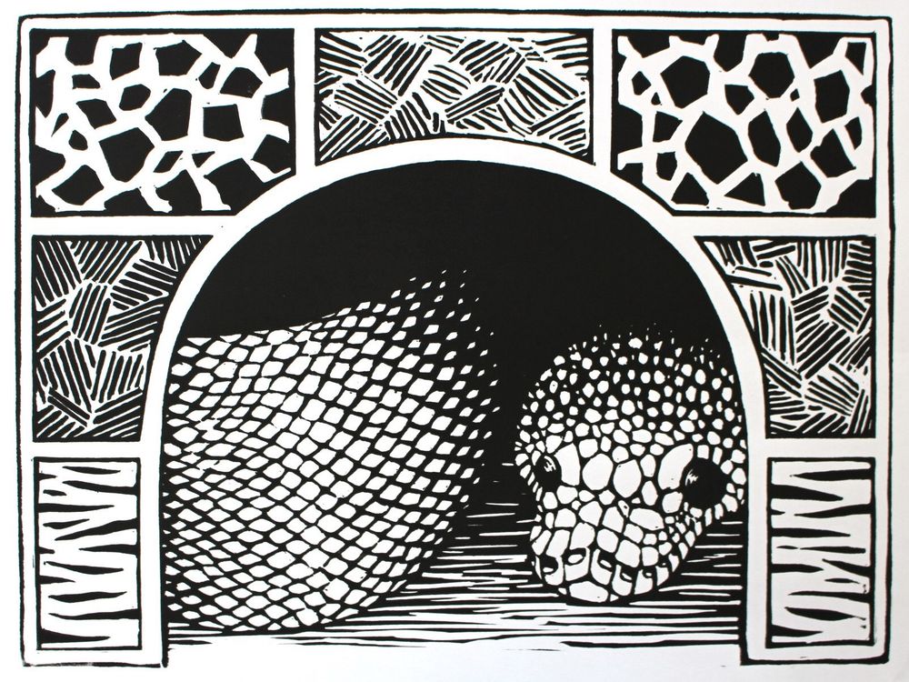 a black and white linoleum block print of a snake in a hide, just the snake’s face and side are visible. The hide has tiles with different textures on it. 
