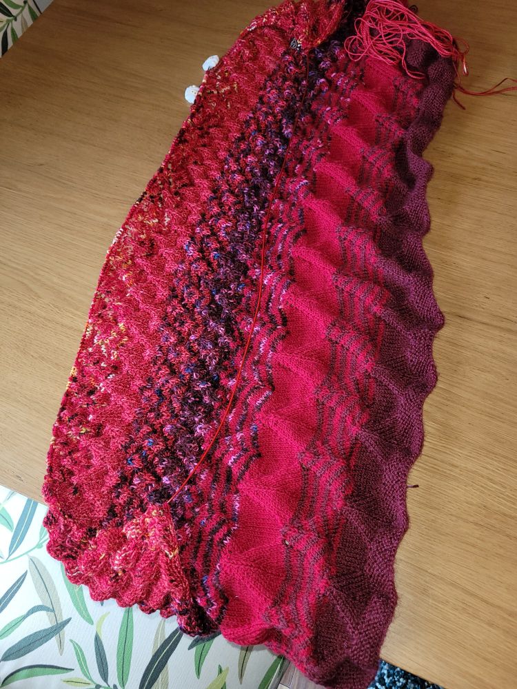 Back of the Falling Leaves Ruana by Genevra Lee. Knitted in Yarnsmiths Merino Sock in Burgundy, Paintbox Sock in Red, Madeline Tosh Sock in Scarlet, Viking Yarns Sock in Viking Blood and All Wool That Ends Wool Sock in Albert Einstein 